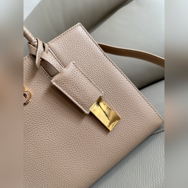 B家最新版型立挺的托特包，采用意大利鞣制粒紋皮革材質制成，搶眼裝飾光澤的 Tho